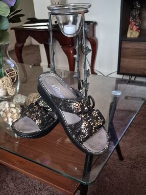 Alegria Black and Gold Slip-On Sandal with Textured Metallic Accents